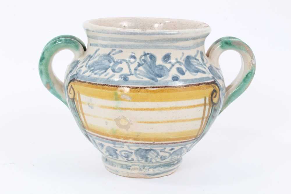 An unusual Italian maiolica twin-handled pot, with blank scrollwork cartouche, probably an apothecar