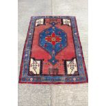 Eastern rug with conjoined medallion and figural motifs on salmon ground, in meande4 borders, 244 x