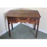 18th century oak lowboy with three drawers above a shaped apron, on square chamfered legs, 86cm x 48