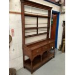 18th century oak dresser with open rack above three drawers and pot board below