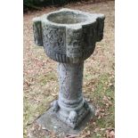 Antique carved stone font, on carved column and square base mounted with seated lions, 108cm high, t