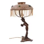Art Nouveau bronzed naked female table lamp with metal shade and moulded glass jewels.
