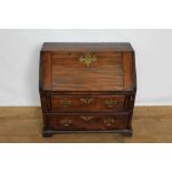 George III fruitwood apprentice bureau, with hinged slope enclosing a fitted interior, two drawers b