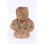 19th century novelty terracotta tobacco jar in the form of a dog wearing a smoking jacket and cap