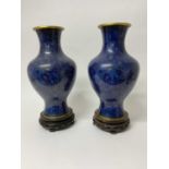 Large pair of Chinese cloisonné blue enamel vases on carved wooden stands
