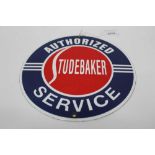 Reproduction circular Studebaker Authorized Service enamel sign, 21.5cm in diameter.