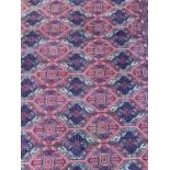 Large rug with geometric decoration on red and blue ground 303cm x 196.5cm