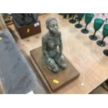 Plaster sculpture of a kneeling woman, on a wooden base, 28cm high