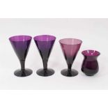 Three 19th century amethyst tinted flared glasses, and a similar tulip shaped cup