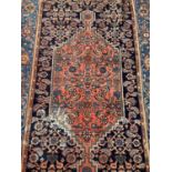 Iranian red and blue rug, 202.5cm x 131cm