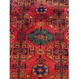 Eastern rug with geometric decoration on red, blue and orange ground, 204cm x 163cm