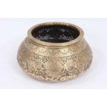 18th/19th century Qajar pierced and tooled brass bowl, of compressed form, engraved with figural res