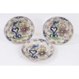 Three small 18th century Delft polychrome dishes, decorated with flowers, 16.5cm diameter