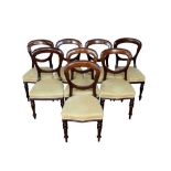 Set of eight Victorian mahogany balloon back dining chairs, each with cream silk upholstery on turne