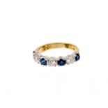 Sapphire and diamond eternity ring with a half hoop of four round mixed cut blue sapphires and three