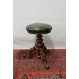 Victorian walnut revolving piano stool the circular green leather rising seat on acanthus carved kno