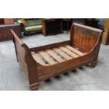 Late 19th / early 20th century chestnut sleigh bed, raised on castors, 116cm wide