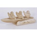 Fine 1930s Eskimo walrus ivory carving of three rowers in a canoe, 12.5cm