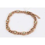 Edwardian 9ct rose gold curb link bracelet set with eight opal cabochons (two missing)
