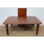 Victorian mahogany extending dining table, with rounded rectangular top on reeded legs and castors,