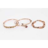 Two late Victorian 9ct gold and gem set hinged bangles and 9ct rose gold gate style bracelet