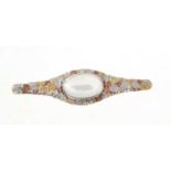 Arts & Crafts handmade brooch with hammered patches of precious metals and set with a central oval m