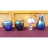 Collection of iridescent and other glass paperweights including fruit and toadstools