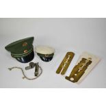 Two miniature German military caps, together with two whistles, brass button polishers and buttons.