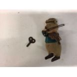 Schuco tinplate clockwork model of a pig playing violin.