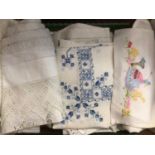 A lot of worked table linens including crochet edged table cloths, pulled thread and cut-out work, e