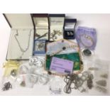 Group of silver chains, some new in packets, silver pendants, earrings and brooches