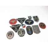 Group of twelve Post War Nazi metal badges and plaques (12)