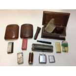 Group of smoking paraphernalia, including a Dunhill lighter, gold mounted cheroot holder, leather ci