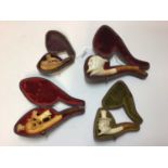 Four cased Meerschaum pipes, including Lucifer, a lion, a deer, and a woman