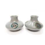 Pair of Moorcroft pottery squat vases each with three circular motifs on grey ground, 8cm high