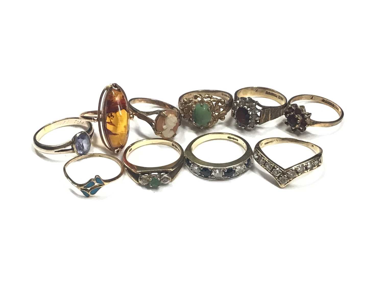 Seven 9ct gold gem set dress rings, gold (583) amber ring, gold (333) blue stone ring and a yellow m