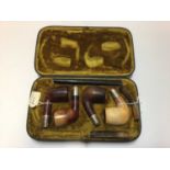 Leather cased set of four pipes (two Meerschaum and two briar), silver mounted and hallmarked Birmin