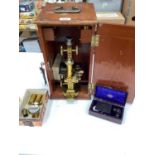 Good quality early 20th century lacquered brass microscope, cased