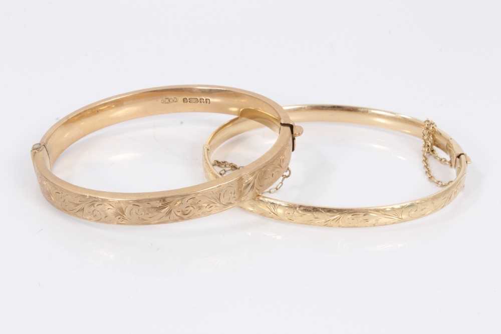 Two 9ct gold bangles, both with engraved scroll decoration