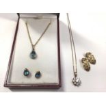 9ct gold pear shaped blue stone pendant on chain and matching pair of earrings, 9ct gold flower head
