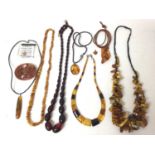 Group amber bead necklaces and pendants including a simulated cherry amber necklace