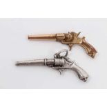 Antique white metal novelty watch winding key in the form of a revolver, together with a similar gol