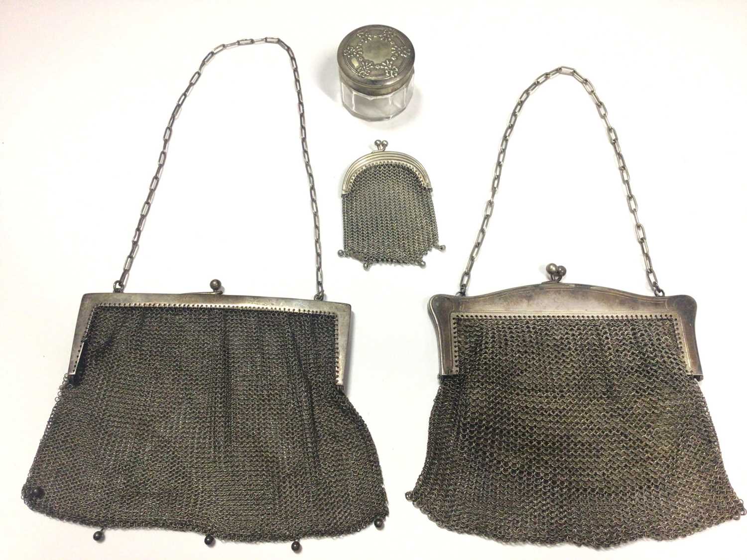 Silver mesh purse, two other silver plated mesh purses and a vanity jar