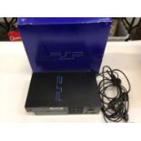 Play Station 2 console in original box with a selection of accessories and games