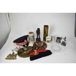 First World War Imperial German Stein, together with brass shell case, military caps and other items