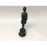After Demetre Chiparus (1886-1947), bronzed figure of a woman standing on a stone base, signed, 34.5