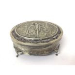 Edwardian silver oval jewellery box on four legs with relief decoration to lid depicting a couple