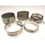 Victorian silver hinged bangle, 1970s silver bangle, two other white metal bangles and contemporary