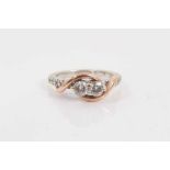 14ct white gold diamond two stone ring with rose gold crossover setting and further diamond set shou