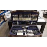 Comprehensive canteen of plated cutlery in 1930s oak cabinet with beaded decoration and spiral twist